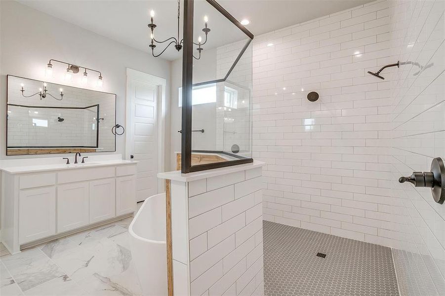 Bathroom featuring separate shower and tub, vanity, and tile floors