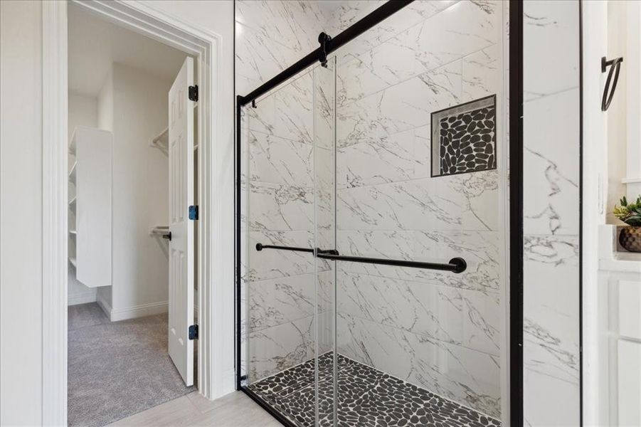 Bathroom featuring a shower with door