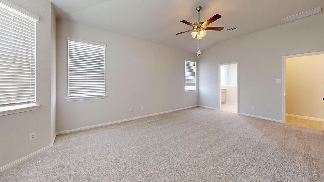 Unfurnished bedroom featuring light carpet, lofted ceiling, a ceiling fan, and ensuite bathroom Unfurnished bedroom featuring light carpet, lofted ceiling, a ceiling fan, and ensuite bathroom