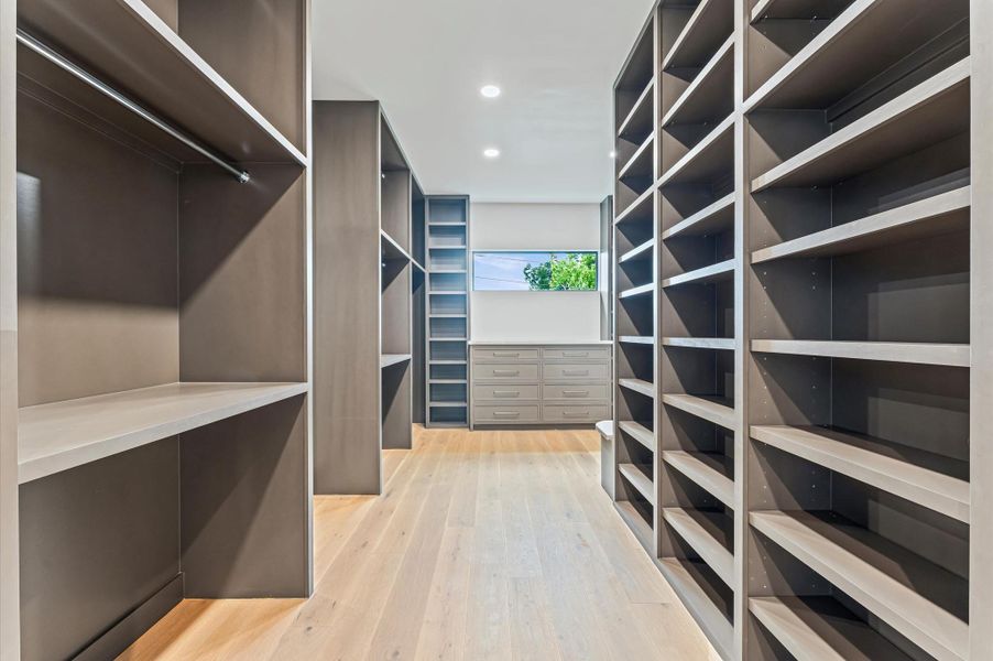 The oversized primary closet has custom 24-inch built-in shelving. The oversized primary closet has custom 24-inch built-in shelving.