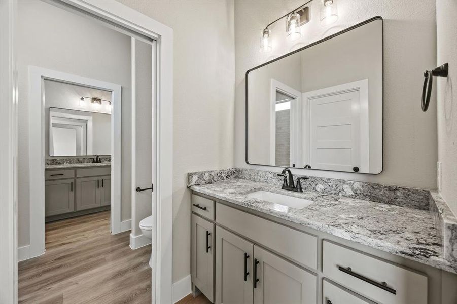 Full bath with vanity and light wood finished floors Full bath with vanity and light wood finished floors
