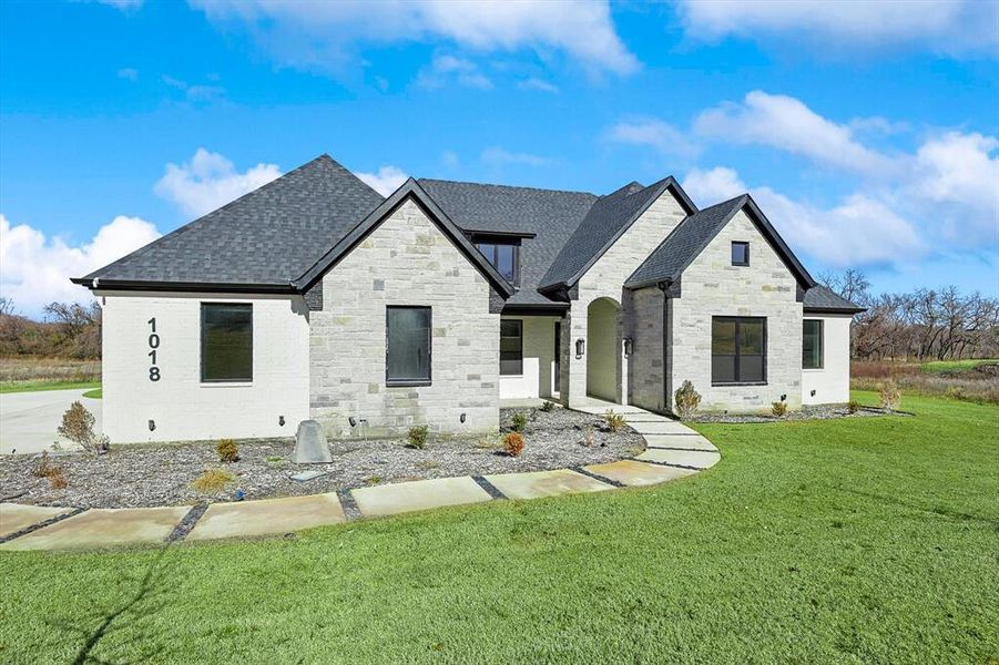 French country style house with a front yard