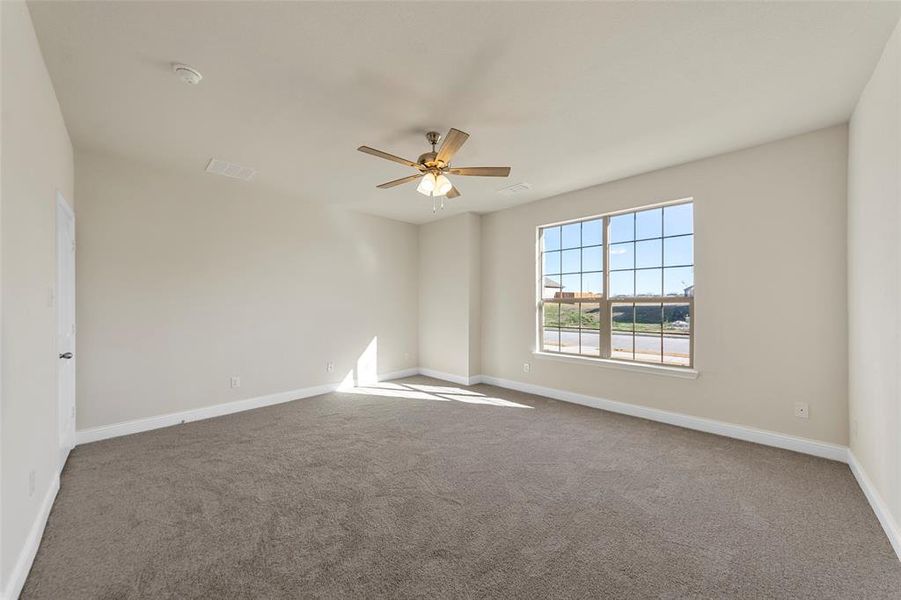 Unfurnished room featuring ceiling fan and carpet floors