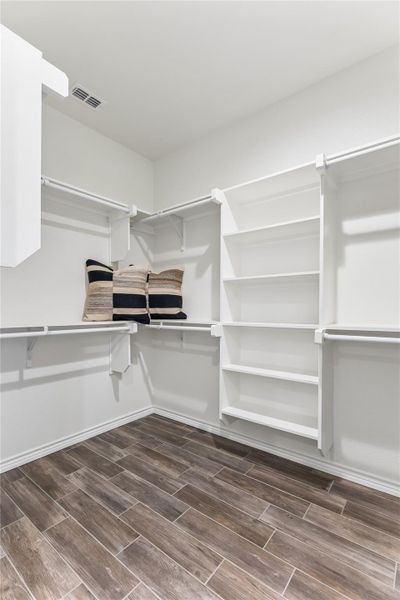 Well-organized closet system features ample shelving and hanging rods.