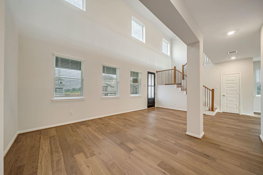 Spacious entry way with formal living room/flex space. The door by the stairway is the half bath.