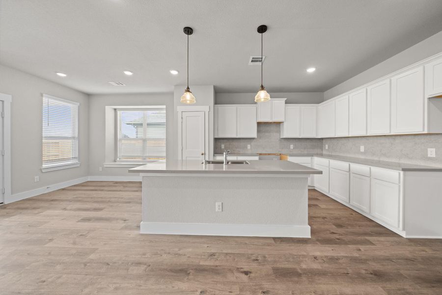 This beautiful brand new kitchen boasts stunning cabinetry that stretches to the ceiling, offering both style and ample storage for all your culinary treasures. REPRESENTATIVE PHOTO