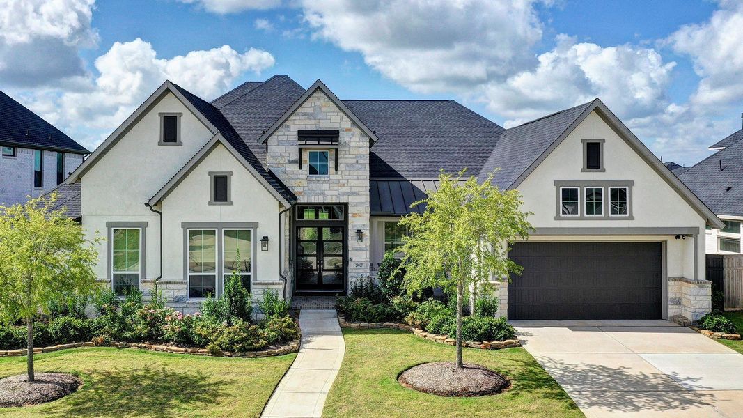 Front exterior of a new home in Cross Creek Ranch 65′, Fulshear, TX, highlighting curb appeal (Image 2). Front exterior of a new home in Cross Creek Ranch 65′, Fulshear, TX, highlighting curb appeal (Image 2).