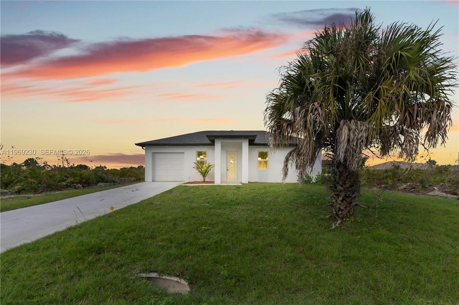 Front exterior of a new home in , Lehigh Acres, FL, highlighting curb appeal (Image 22).