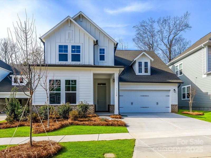 Front exterior of a new home in North Creek Village, Huntersville, NC, highlighting curb appeal (Image 22).