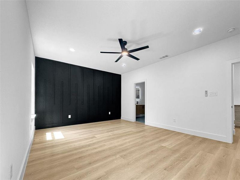 Unfurnished bedroom featuring a ceiling fan, light wood-style flooring, ensuite bath, and recessed lighting