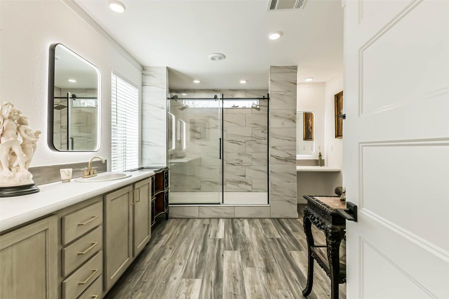 Master bath w/ back-lit mirrors throughout & Large double headed shower.