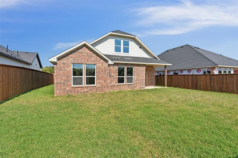 Back of property with a patio and a yard