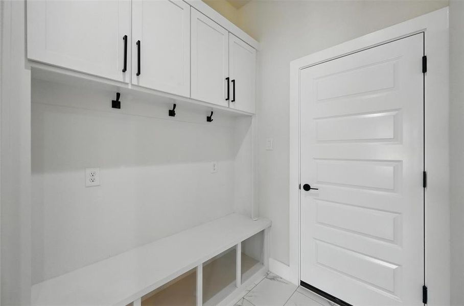Mudroom with light marble finish floors Mudroom with light marble finish floors