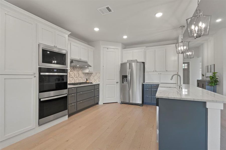 Added Custom Cabinetry to left of Double ovens and they have pull out drawers
