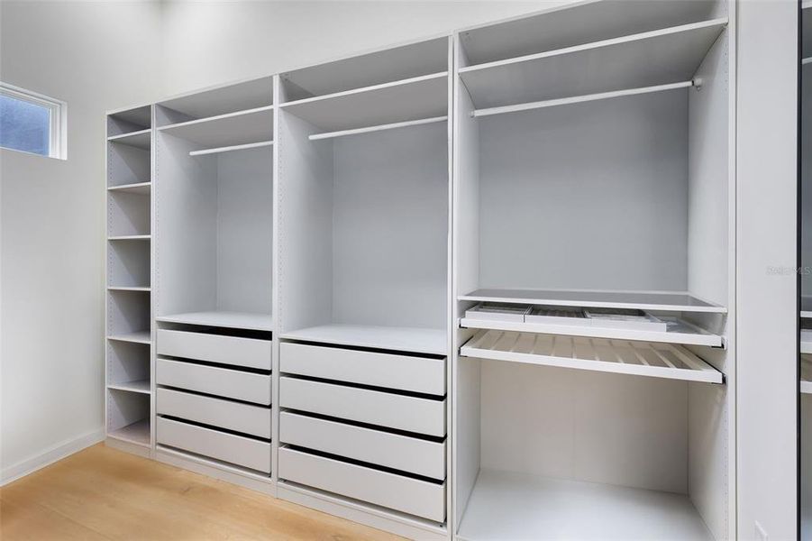 Dual walk-in closets include built-in storage.