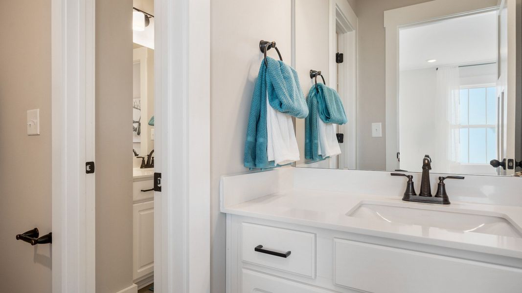 Top-notch bathroom with current fixtures, tasteful materials, and elevated charm at the Wells Crossing community