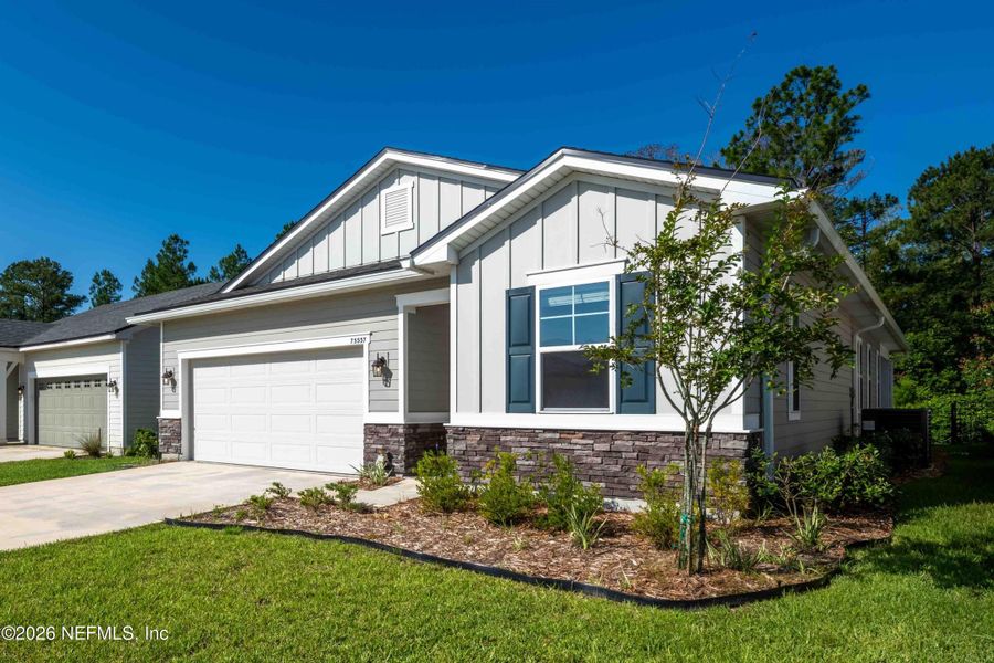 Front exterior of a new home in Tributary, Yulee, FL, highlighting curb appeal (Image 2). Front exterior of a new home in Tributary, Yulee, FL, highlighting curb appeal (Image 2).