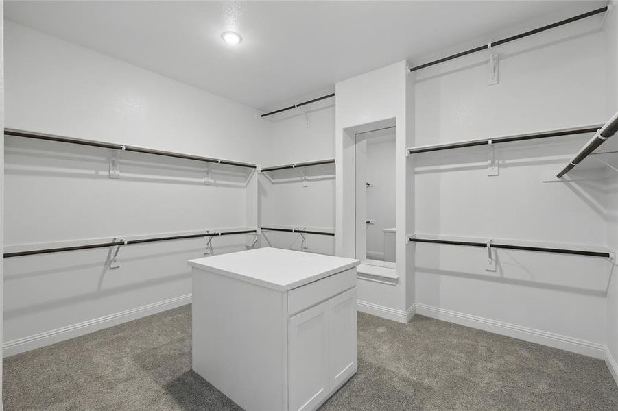 Walk in closet featuring light carpet
