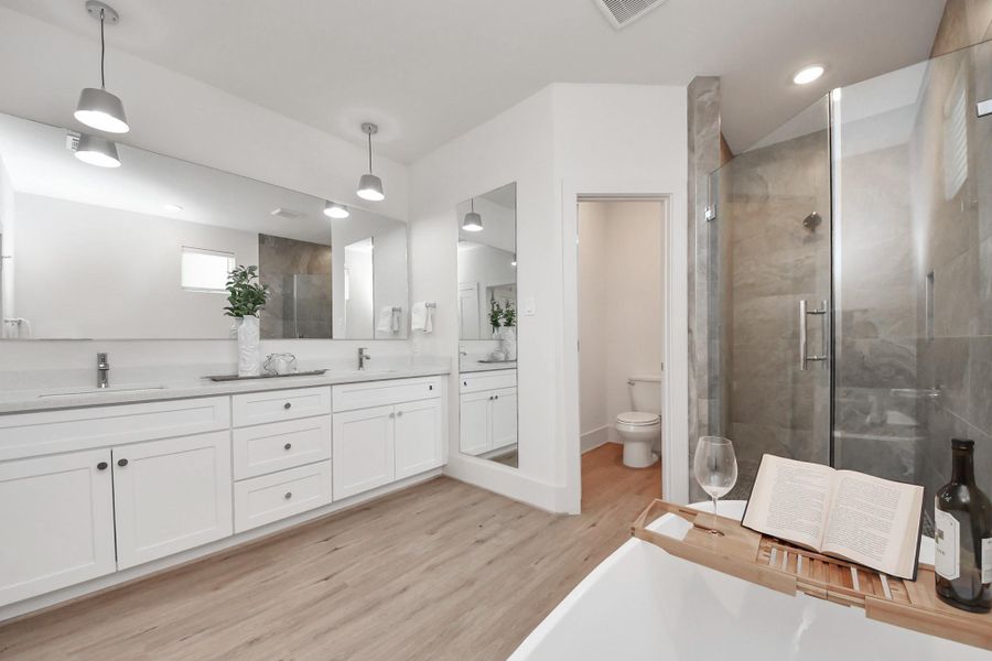 Illuminated by natural light pouring in from the nearby window, this perspective highlights the stunning design of the main bathroom. Illuminated by natural light pouring in from the nearby window, this perspective highlights the stunning design of the main bathroom.