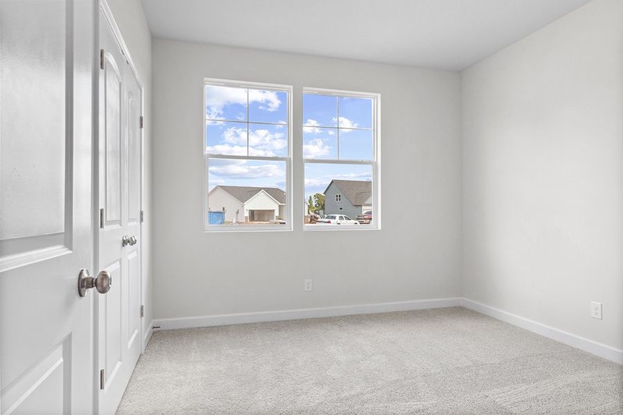 A room with a window and a carpet. A room with a window and a carpet.