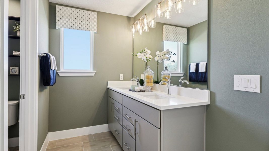 The Mangrove Model Primary Bath with Dual Sinks at Lakeside at Satilla by DRB Homes in Saint Cloud, FL