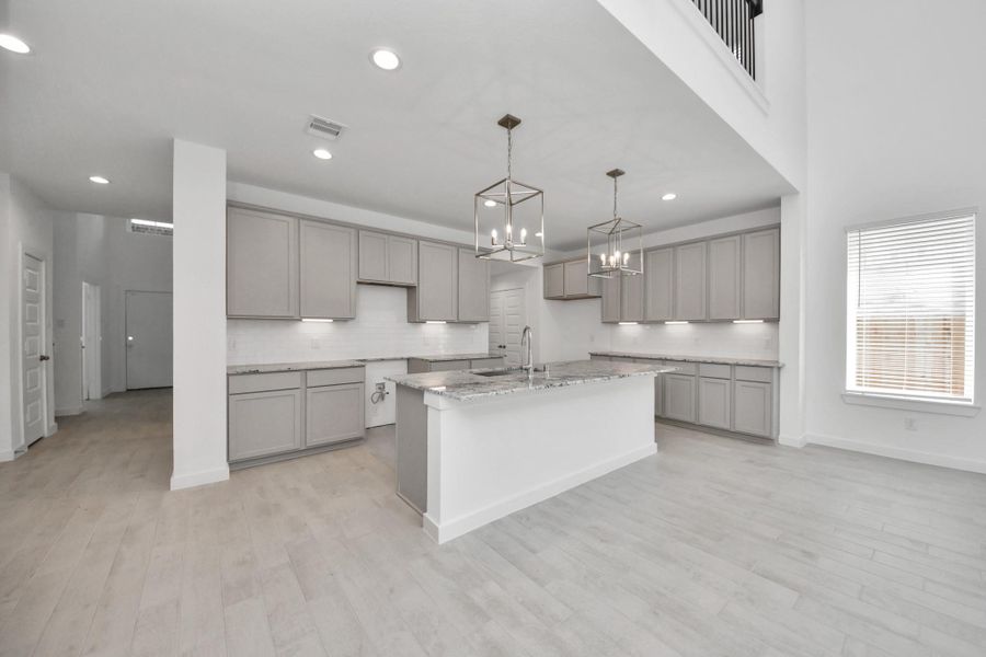 The open concept effortlessly connects the kitchen to the expansive family room, forming a perfect hub for gatherings. This seamless flow creates an inviting space where cooking and socializing come together harmoniously. Sample photo of completed home with similar floor plan. Actual colors and selections may vary.