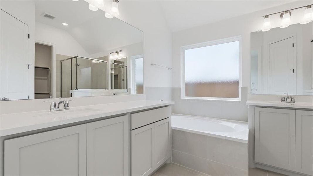 Dual vanities with white countertops and undermount sinks Dual vanities with white countertops and undermount sinks