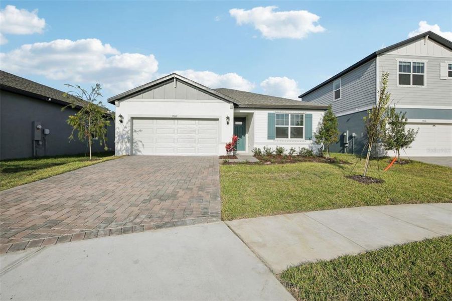 Front exterior of a new home in Coasterra - Reserve Series, Palmetto, FL, highlighting curb appeal (Image 2). Front exterior of a new home in Coasterra - Reserve Series, Palmetto, FL, highlighting curb appeal (Image 2).