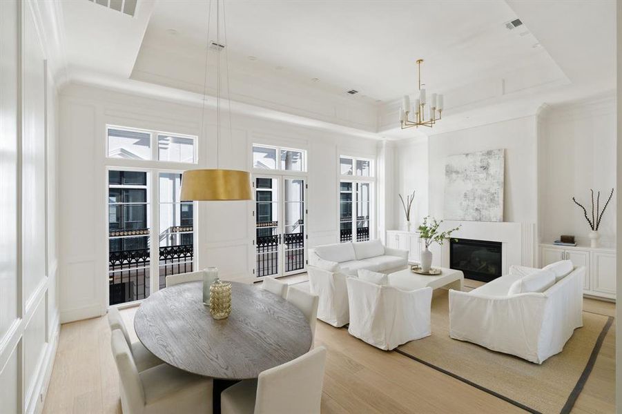 The open concept second floor living areas feature show-stopping fourteen foot ceilings and a designer lighting package. (photo of interior model home with smaller floor plan)