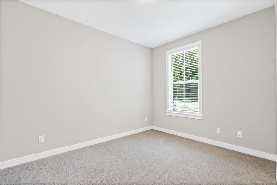 Neutral-toned room with a single window, white trim, and light gray carpeting Neutral-toned room with a single window, white trim, and light gray carpeting