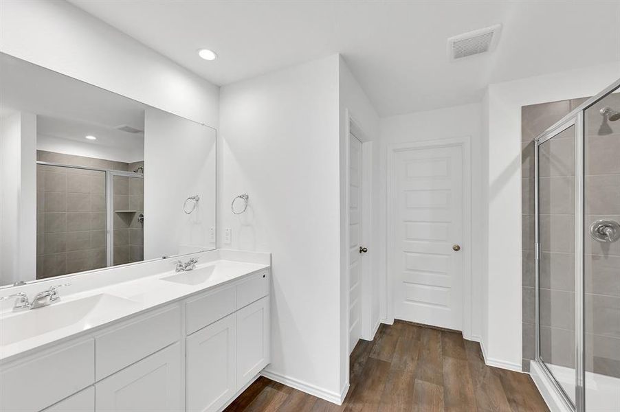 A double-sink vanity provides convenient shared use for both homeowners, allowing for a more organized and efficient daily routine.