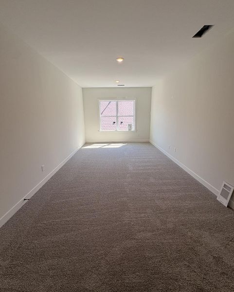 Unfurnished room with carpet flooring and baseboards