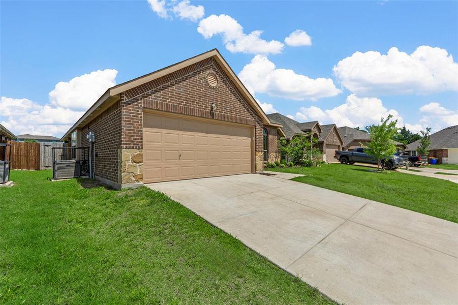 View of front of property featuring brick siding, driveway, and an attached garage View of front of property featuring brick siding, driveway, and an attached garage
