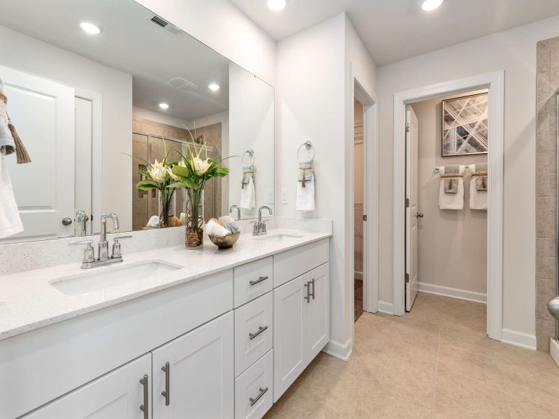 The primary bath offers dual vanity sinks.