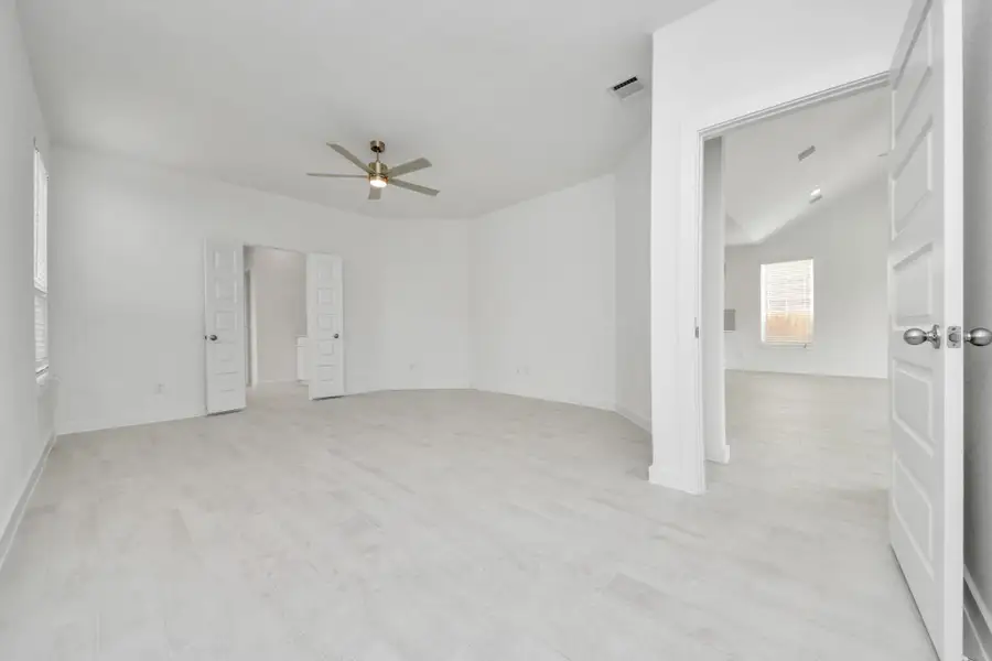 Come and unwind after a long day in this magnificent primary suite! This spacious room features warm paint, high ceilings and large windows with privacy blinds.