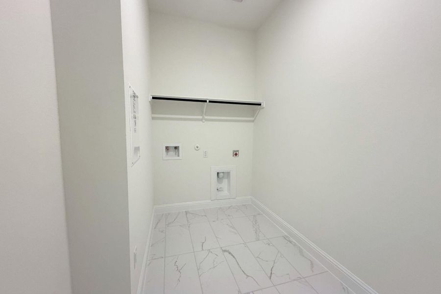 Laundry area featuring hookup for a gas dryer, light marble finish flooring, and washer hookup