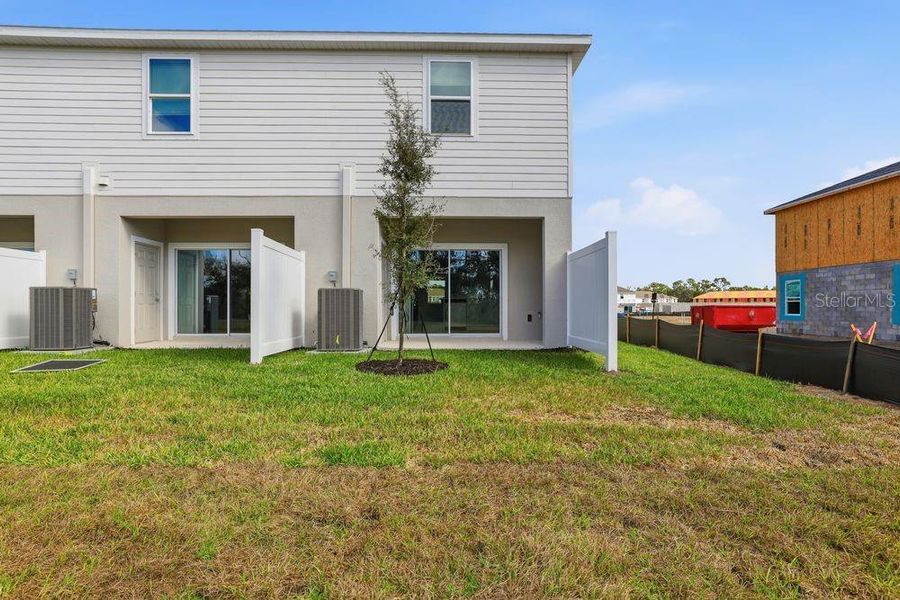 Exterior details and patio area of a home in The Towns at Firethorn, Parrish (Image 19).