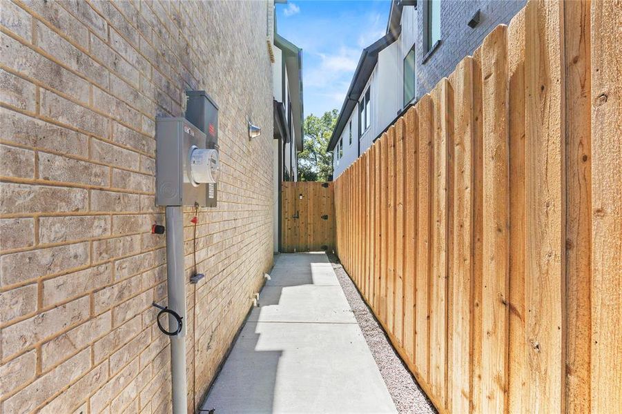 View of side of property featuring a gate View of side of property featuring a gate
