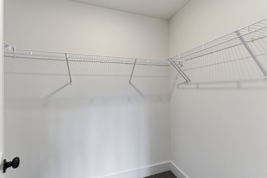 A white wall with a metal railing.