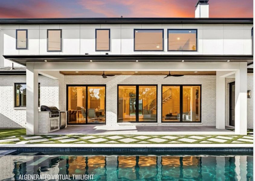 Back of house at dusk featuring ceiling fan, a patio area, an outdoor pool, and exterior kitchen Back of house at dusk featuring ceiling fan, a patio area, an outdoor pool, and exterior kitchen