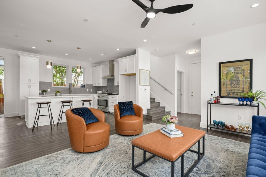 An open floor plan seamlessly connects the kitchen and living area, featuring rich hardwood flooring throughout. An open floor plan seamlessly connects the kitchen and living area, featuring rich hardwood flooring throughout.