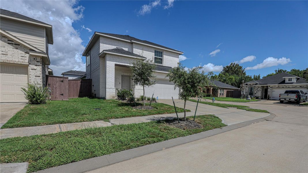 Front exterior of a new home in Woodshore, Clute, TX, highlighting curb appeal (Image 22).