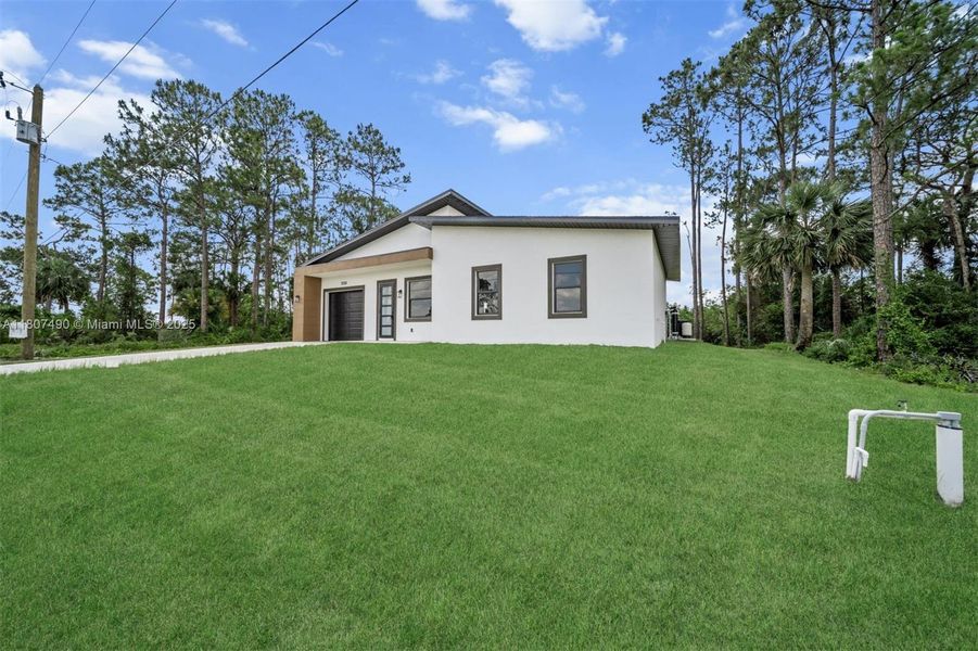 Front exterior of a new home in , Lehigh Acres, FL, highlighting curb appeal (Image 15). Front exterior of a new home in , Lehigh Acres, FL, highlighting curb appeal (Image 15).