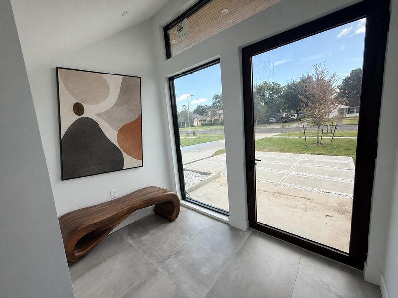 Bright entryway with large windows offering a welcoming atmosphere.