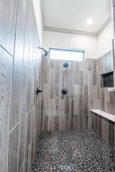 Full bathroom with crown molding and a tile shower Full bathroom with crown molding and a tile shower