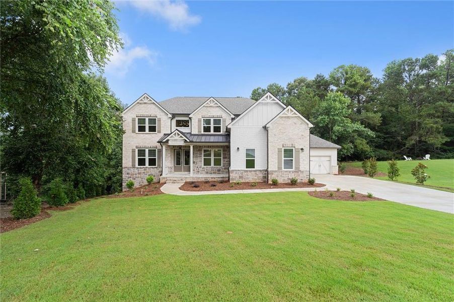 Front exterior of a new home in , Flowery Branch, GA, highlighting curb appeal (Image 1). Front exterior of a new home in , Flowery Branch, GA, highlighting curb appeal (Image 1).