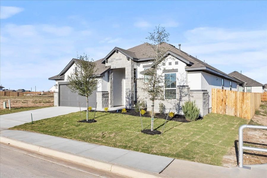 Front exterior of a new home in Village at Three Oaks, Seguin, TX, highlighting curb appeal (Image 22). Front exterior of a new home in Village at Three Oaks, Seguin, TX, highlighting curb appeal (Image 22).