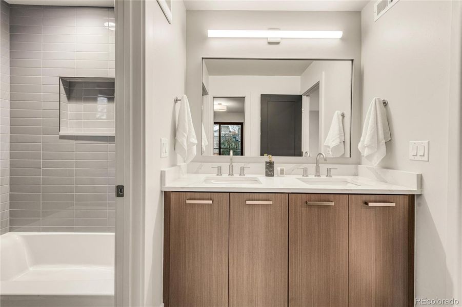 Dual vanity in shared bathroom.