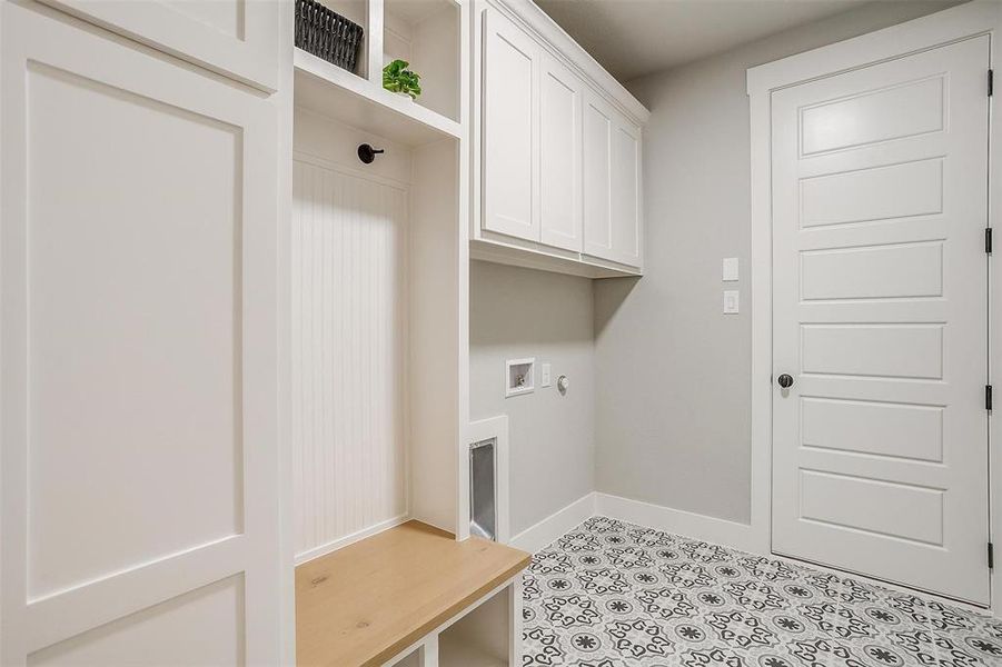 Laundry room with baseboards, cabinet space, and hookup for a washing machine Laundry room with baseboards, cabinet space, and hookup for a washing machine