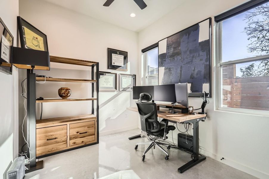 Spacious secondary bedroom on the main floor with plenty of natural light — perfect for guests, a home office, or a cozy retreat.